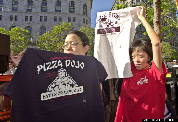 Annie Koh, left, and Katie Lee, right, both of San Francisco, hold up controversial t-shirts as they demonstrate in front of the Abercrombie & Fitch store in San Francisco, Thursday, April 18, 2002. The protestors were upset at five T-shirts from the trendy clothing store depicting stereotypes of Asians that has prompted an e-mail and phone campaign to boycott the retailer. (AP Phoito/Paul Sakuma)