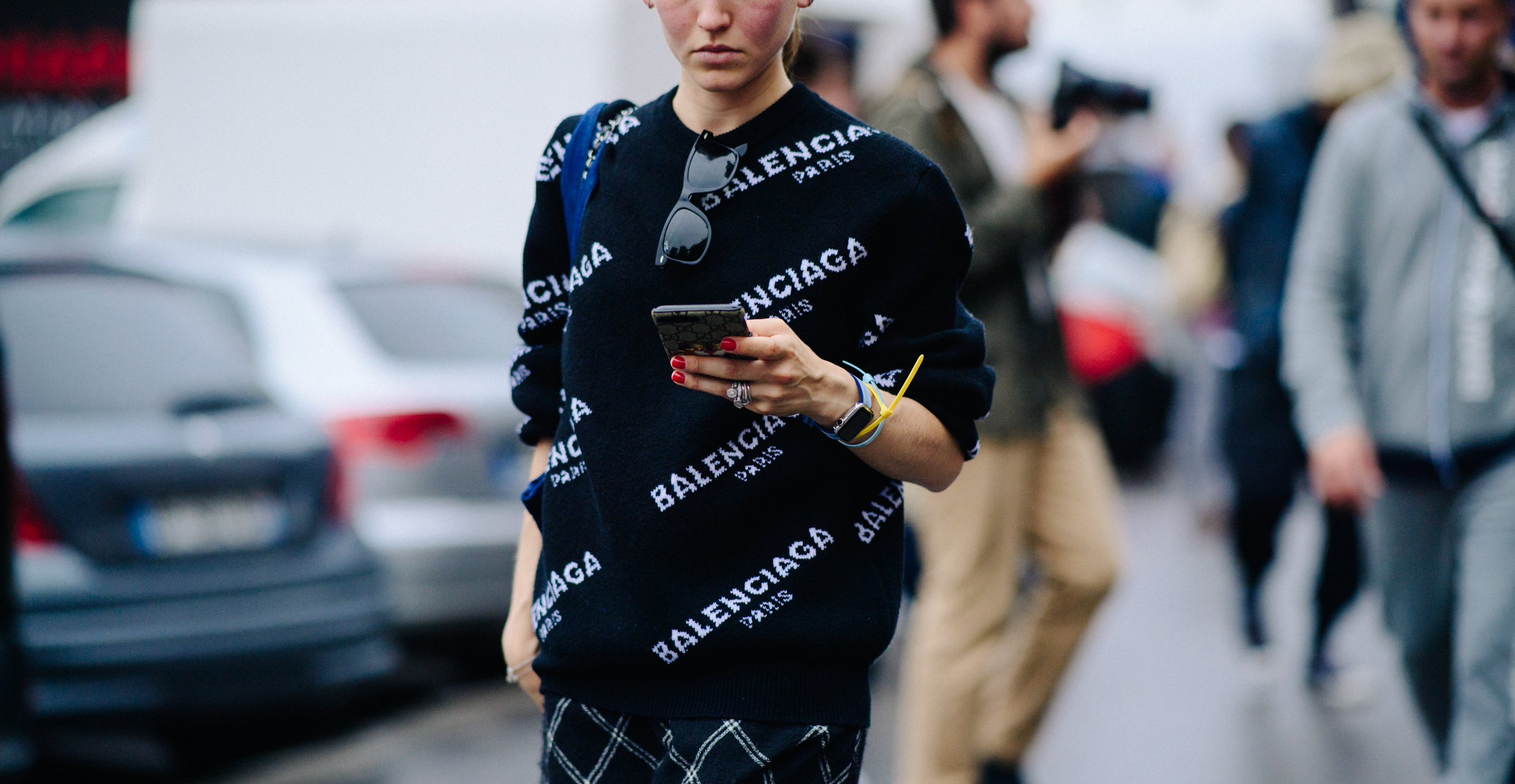 Woman wearing sweater with Balenciaga logo