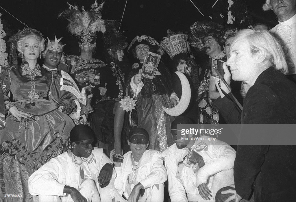 Andy Warhol at Le Palace nightclub. Andy Warhol is photographing a group of revelers that includes Karl Lagerfeld and Paloma Picasso. (Photo by Francis Apesteguy/Getty Images)